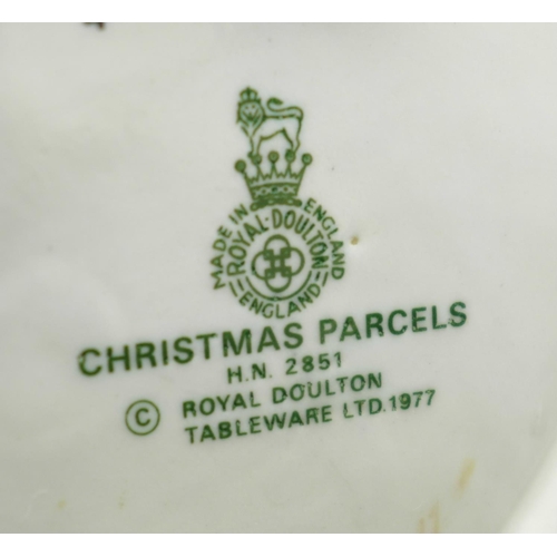 614 - A Royal Doulton figure, Christmas Parcels, a/f (umbrella handle re-glued)