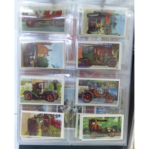 680 - An album of fourteen complete sets of cigarette cards, an album of nine sets of trade cards and two ... 