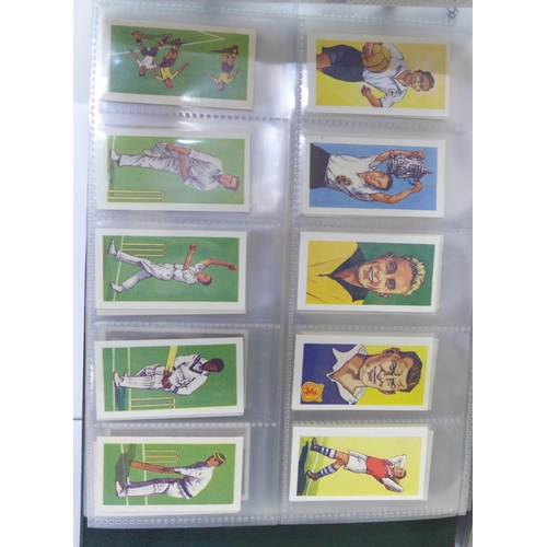 680 - An album of fourteen complete sets of cigarette cards, an album of nine sets of trade cards and two ... 