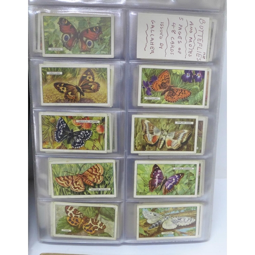 680 - An album of fourteen complete sets of cigarette cards, an album of nine sets of trade cards and two ... 