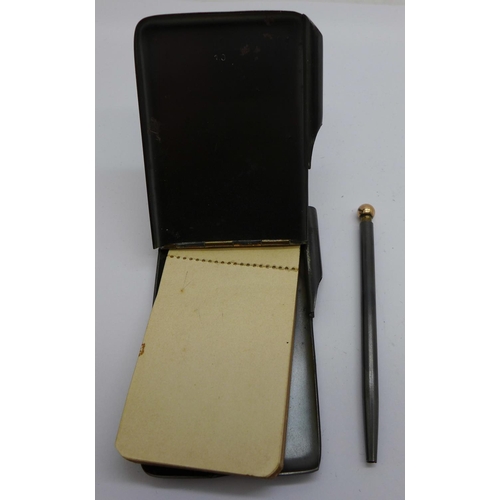 759 - A gun metal notebook case with pencil, set with turquoise and with plated mounts