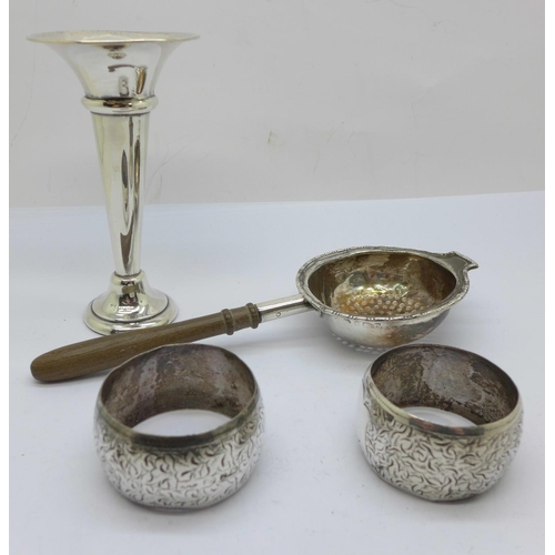 787 - A pair of silver napkin rings, a silver posy vase and a silver strainer