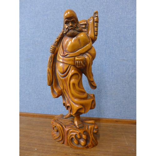 310 - An oriental carved wood figure of a sage