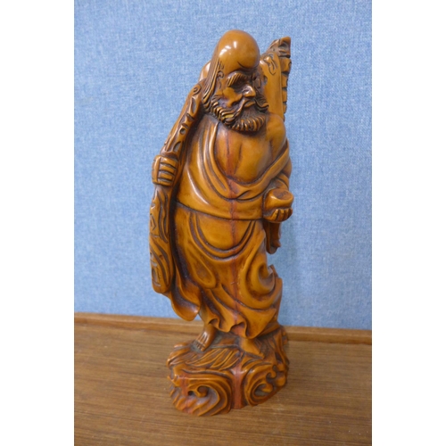 310 - An oriental carved wood figure of a sage