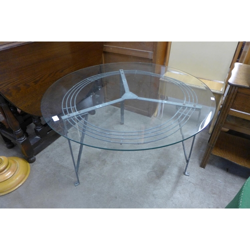 249 - A steel and glass topped circular coffee table