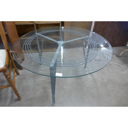 249 - A steel and glass topped circular coffee table