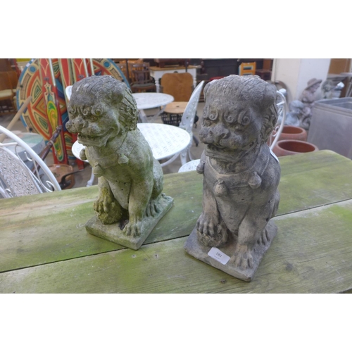 281 - A pair of reconstituted stone dogs of foe