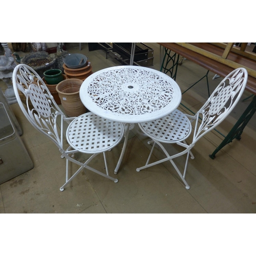 289 - A cast alloy garden table and two chairs