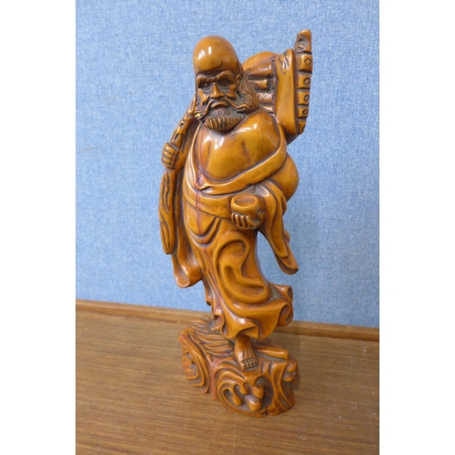 310 - An oriental carved wood figure of a sage