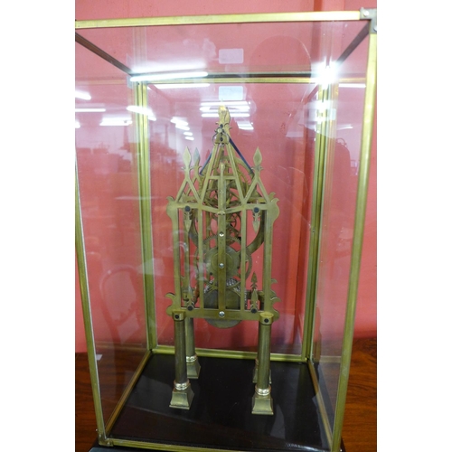 54 - A brass skeleton clock, cased (missing key and pendulum)