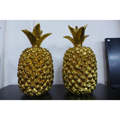 92 - A pair of gilt figural pineapples