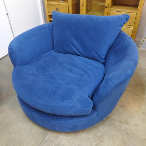 1443 - A blue upholstered swivel armchair