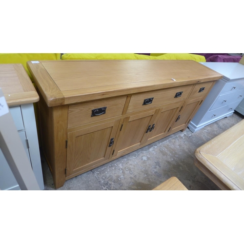 1591 - An oak four door, three drawer sideboard  *This lot is subject to VAT