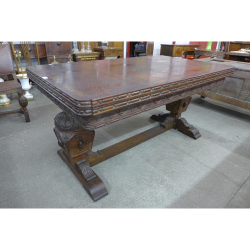 99 - A carved oak draw-leaf table