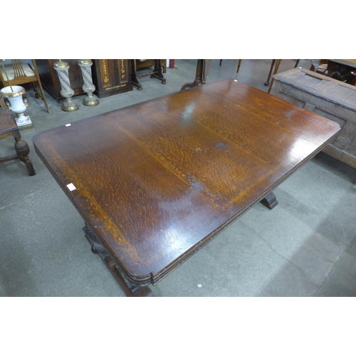 99 - A carved oak draw-leaf table