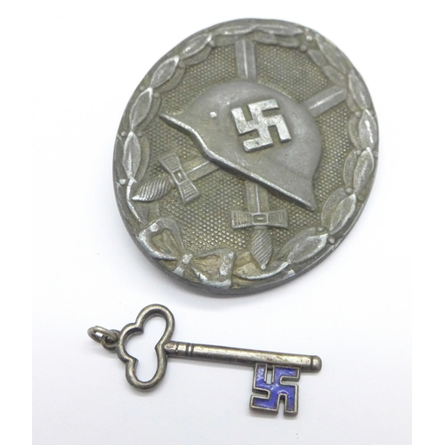 1088 - A German badge, lacking hook, and a small enamelled key charm with National Socialist emblem