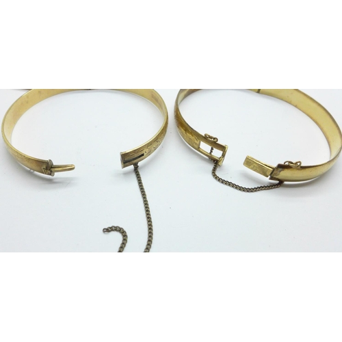 1104 - A 9ct gold, bronze core bangle and two rolled gold bangles