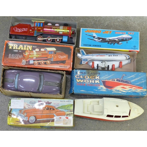 692 - Four boxed toys, Minister Delux Car, Train, long range clockwork Cabin Cruiser and Jumbo Jet