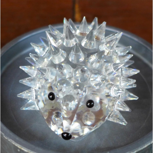 709 - Six items of Swarovski crystal and other crystal including owl, hedgehog and clown brooch, and a Bal... 