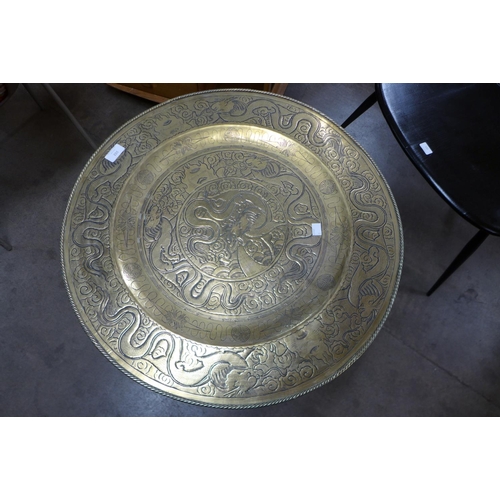 102 - A Chinese brass topped folding occasional table