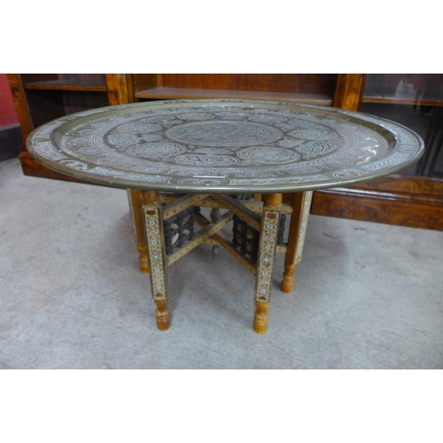 103 - An Islamic brass topped folding table