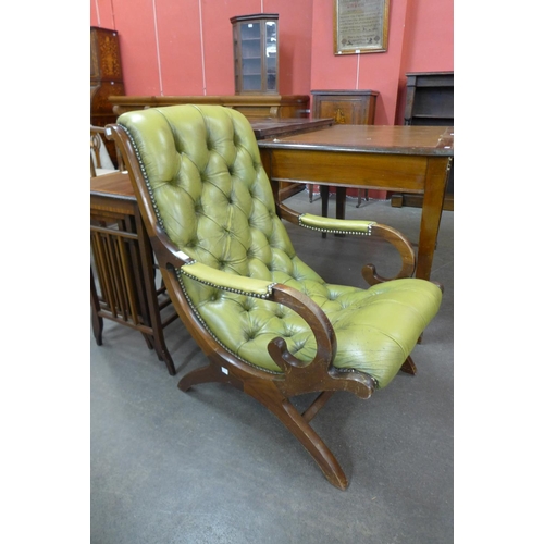 111 - A mahogany and green leather armchair