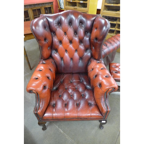 112 - A red leather Chesterfield wingback armchair