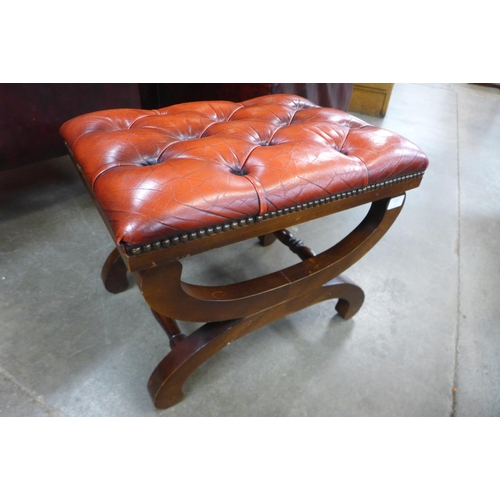 113 - A mahogany and red leather x-frame footstool