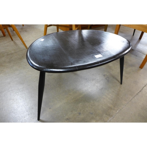 132 - An Ercol black pebble shaped occasional table