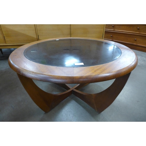 139 - A teak and glass topped circular coffee table