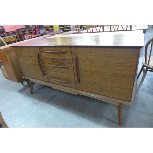 149 - An Alfred Cox walnut six piece dining suite, comprising sideboard, table and four chairs