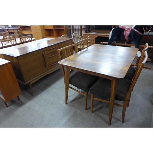 149 - An Alfred Cox walnut six piece dining suite, comprising sideboard, table and four chairs