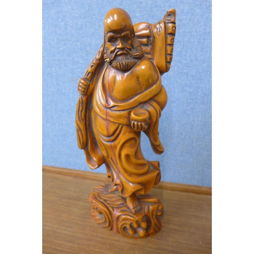 335 - An oriental carved wood figure of a sage