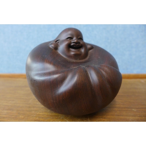 336 - An oriental carved hardwood Buddha