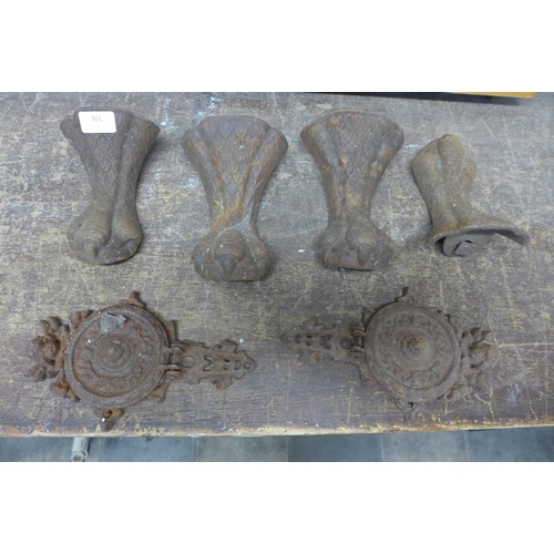 361 - A set of four cast metal feet and wall brackets