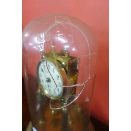 43 - A brass anniversary clock, glass dome a/f