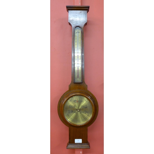 47 - An oak aneroid barometer, the brass dial signed Nedham, Leicester