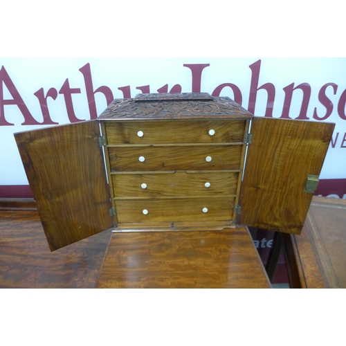 84 - A Victorian carved walnut table top collectors cabinet