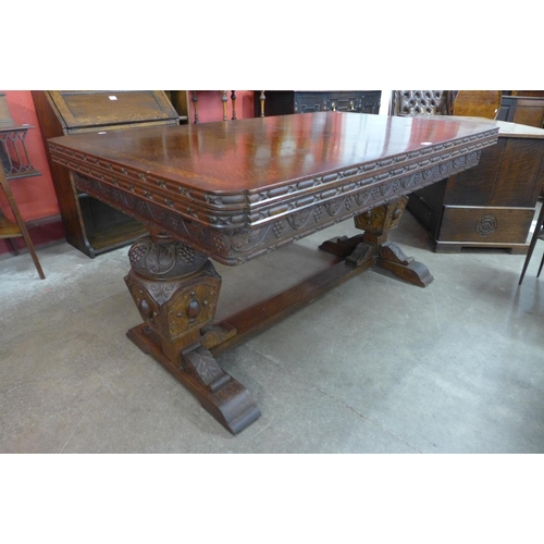 99 - A carved oak draw-leaf table