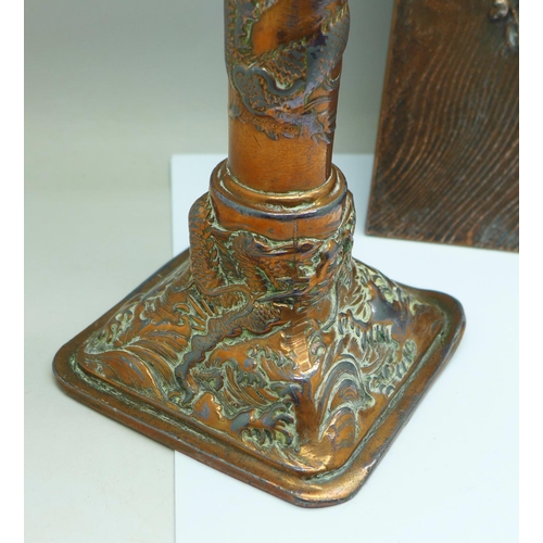 670 - An Art Nouveau copper frame and a Chinese candlestick