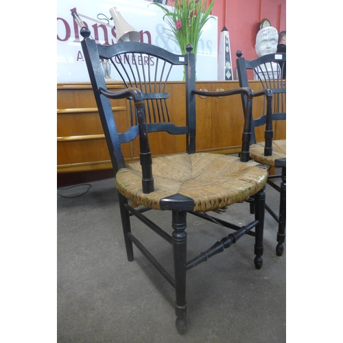 87 - A pair of William Morris Arts and Crafts ebonised and rush seated Rosetti chairs