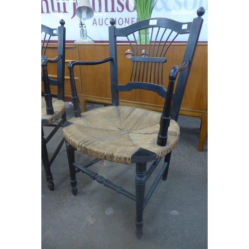 87 - A pair of William Morris Arts and Crafts ebonised and rush seated Rosetti chairs