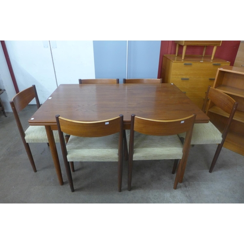 102 - A Danish teak extending draw-leaf dining table and six Frem Rojle teak dining chairs