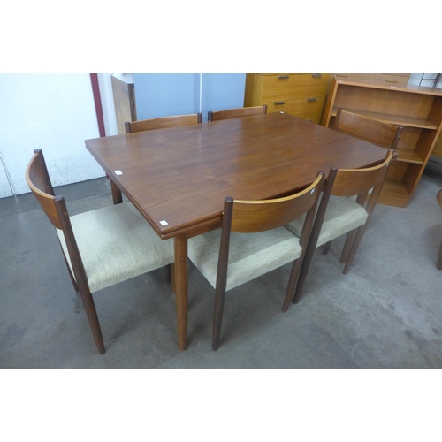 102 - A Danish teak extending draw-leaf dining table and six Frem Rojle teak dining chairs