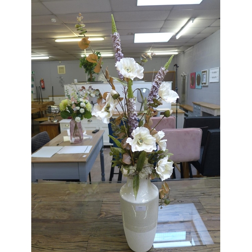 1602 - A cream/beige tall ceramic vase with arrangement of silk cream poppies, height 1 metre