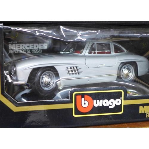 614 - Four 1 1/18 scale die-cast model vehicles, Mercedes Benz 300SL 1954 and SSK 1928, Ford Model T Touri... 