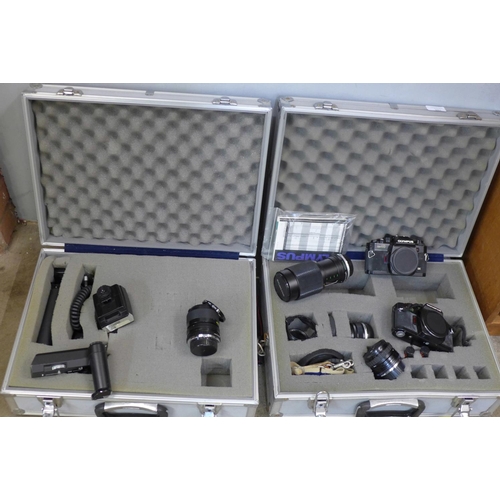 784 - Olympus OM40 35mm film cameras x2, four lenses, (Sigma mini-wide II 1:2.8, Olympus Auto-S 50mm 1:1.8... 
