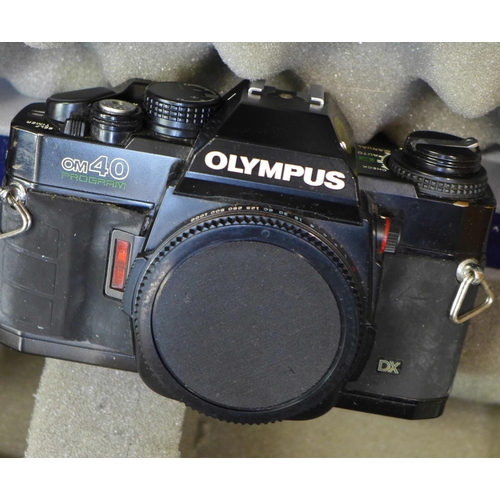 784 - Olympus OM40 35mm film cameras x2, four lenses, (Sigma mini-wide II 1:2.8, Olympus Auto-S 50mm 1:1.8... 
