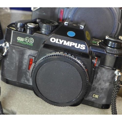 784 - Olympus OM40 35mm film cameras x2, four lenses, (Sigma mini-wide II 1:2.8, Olympus Auto-S 50mm 1:1.8... 