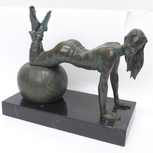 808 - A bronze figure of a girl exercising on a black onyx plinth